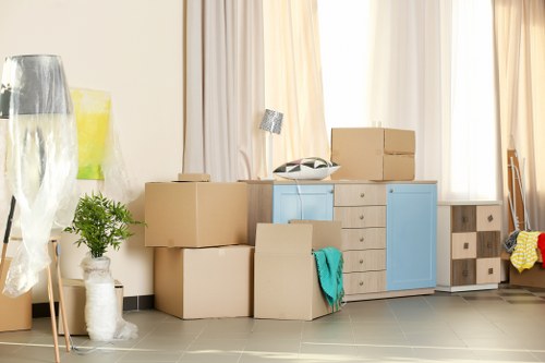 Removal team preparing a home move in Swiss Cottage with boxes and furniture