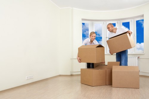 Packing boxes and wrapping belongings for a home move in Swiss Cottage