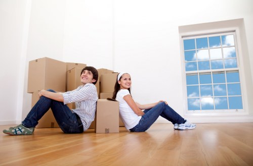 Careful unpacking of household items in a Swiss Cottage flat