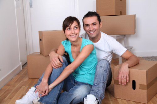 Mover wearing PPE while transporting furniture carefully