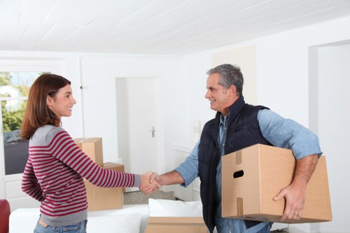 Loading furniture into a van near Swiss Cottage flats