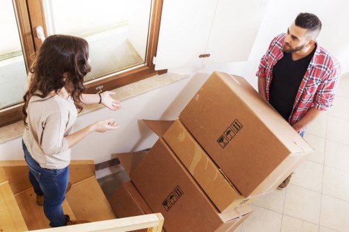 Professional movers loading household items in Swiss Cottage