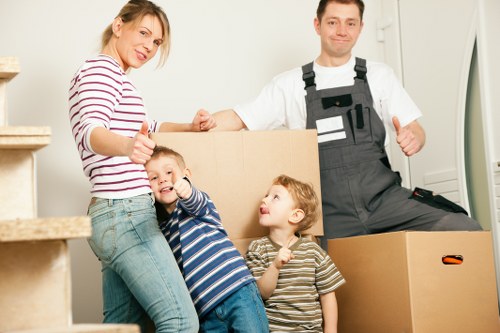 Packed boxes and household items ready for urgent removals in Swiss Cottage